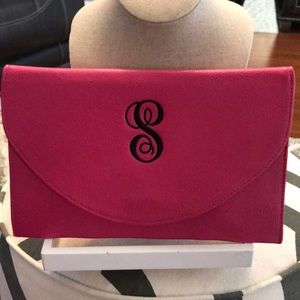 Pink monogrammed clutch with chain